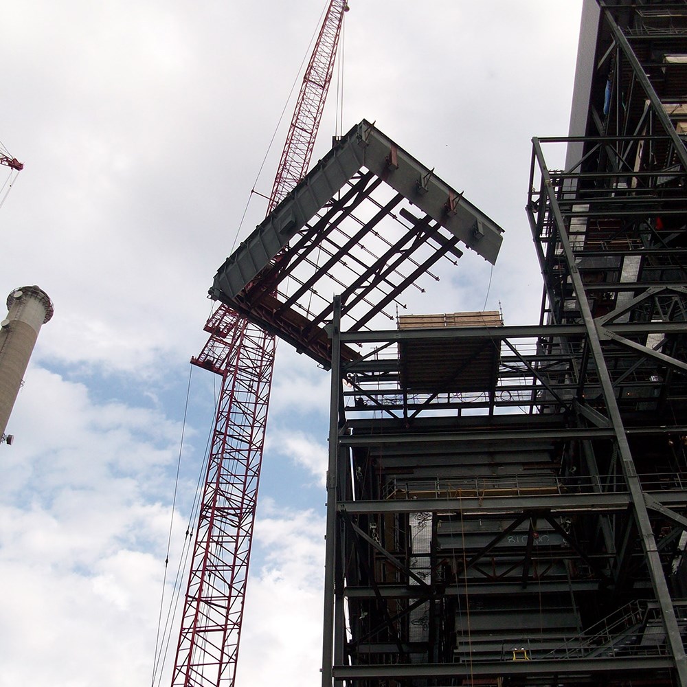 A crane lowers a section of the Iatan Generating Station into place.